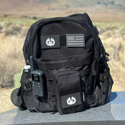TORCH EDC Admin Pouch in black shown outdoors attached to tactical backpack with gear for hiking or travel use.