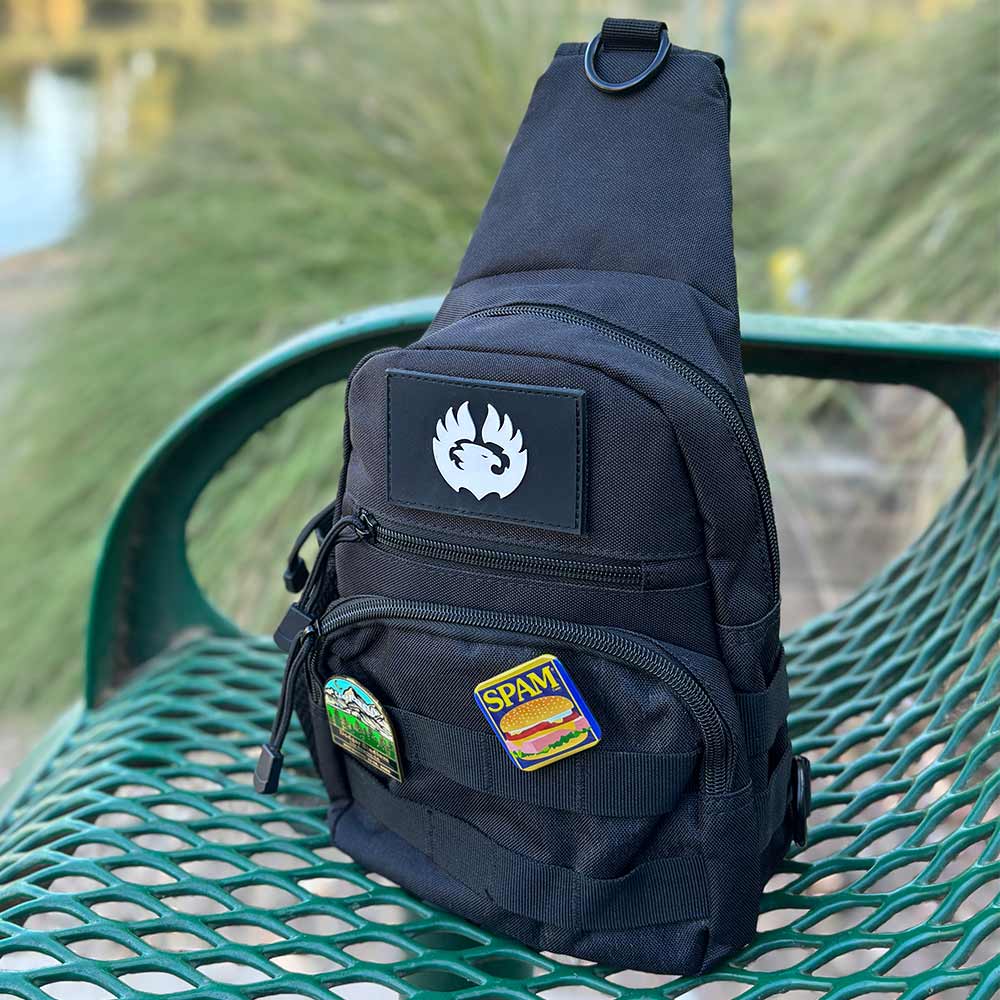 TORCH EDC Chest Pack V2 black on bench in outdoor park setting – minimalist EDC sling bag