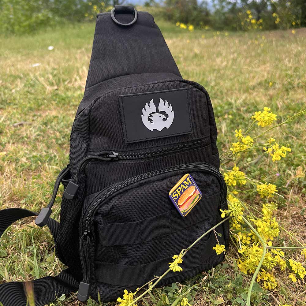 TORCH EDC Chest Pack V2 black in grassy field – compact crossbody for travel and EDC gear