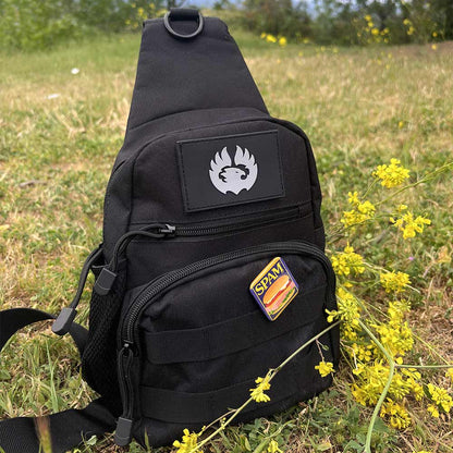 TORCH EDC Chest Pack V2 black in grassy field – compact crossbody for travel and EDC gear